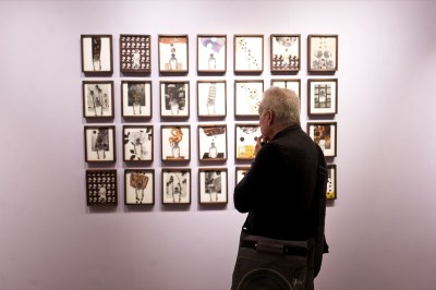 A visitor looks at an series of works by Christa David at Gallery 193's booth at 1-54 Contemporary African Art Fair in New York.