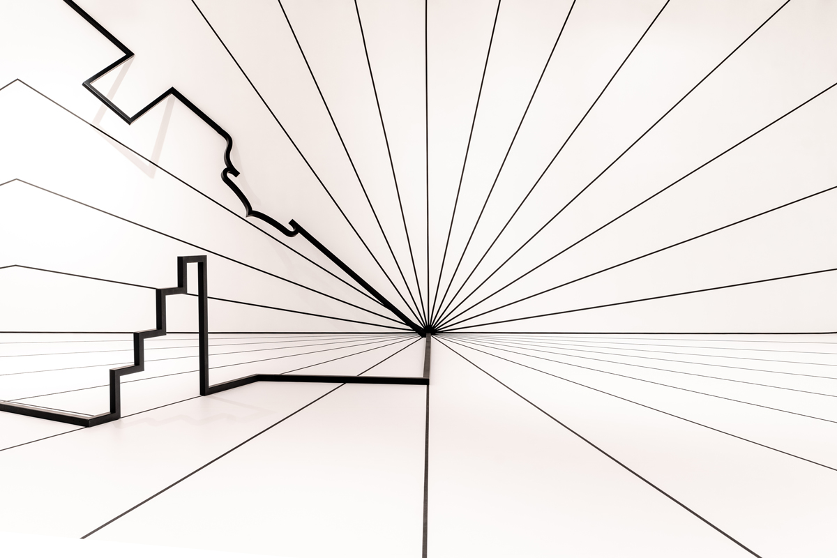 A white wall showing two-point perspective of several black lines.