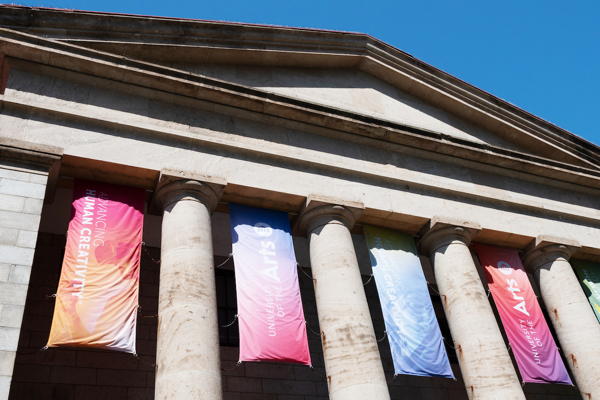 A columned building with banners between its columns.